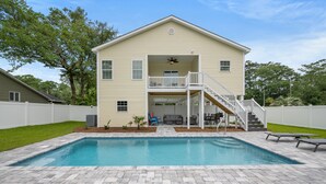 A two-story house with a front deck, a swimming pool, and a covered patio area. - Castaway Cay - Beautiful 4 BR House with Pool (North Myrtle Beach)