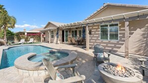 A backyard with a swimming pool, a hot tub, and a fire pit. - Desert Golf Getaway by GPM -Tennis+Pickleball+Priv. Pool+More! Walk to Festivals (Indio)