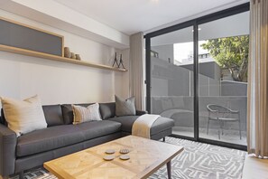 Apartment (1 Bedroom) | Living area | 42-inch LED TV with satellite channels, TV, Netflix - The Cedar Unit 101 (Cape Town)