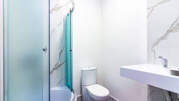 Shower, hair dryer, towels, toilet paper