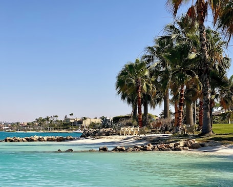 Private beach nearby, white sand, beach shuttle, beach umbrellas