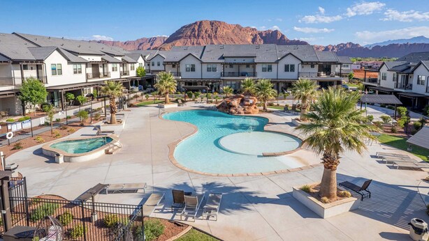 A resort with multiple pools, a mountain backdrop, and a well-maintained outdoor area with lounge chairs. - Coral Paradise Community Pool (Santa Clara)