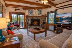 A cozy living room with a fireplace, comfortable seating, and a television. - "Bigfoot Bungalow" Dog-friendly oasis - Right next to the bike trails! (Snowshoe)