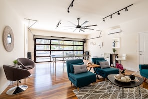 House, Multiple Beds, Pool Access, Pool View (Haleola Palm Springs) | Living area | 50-inch flat-screen TV with digital channels, fireplace