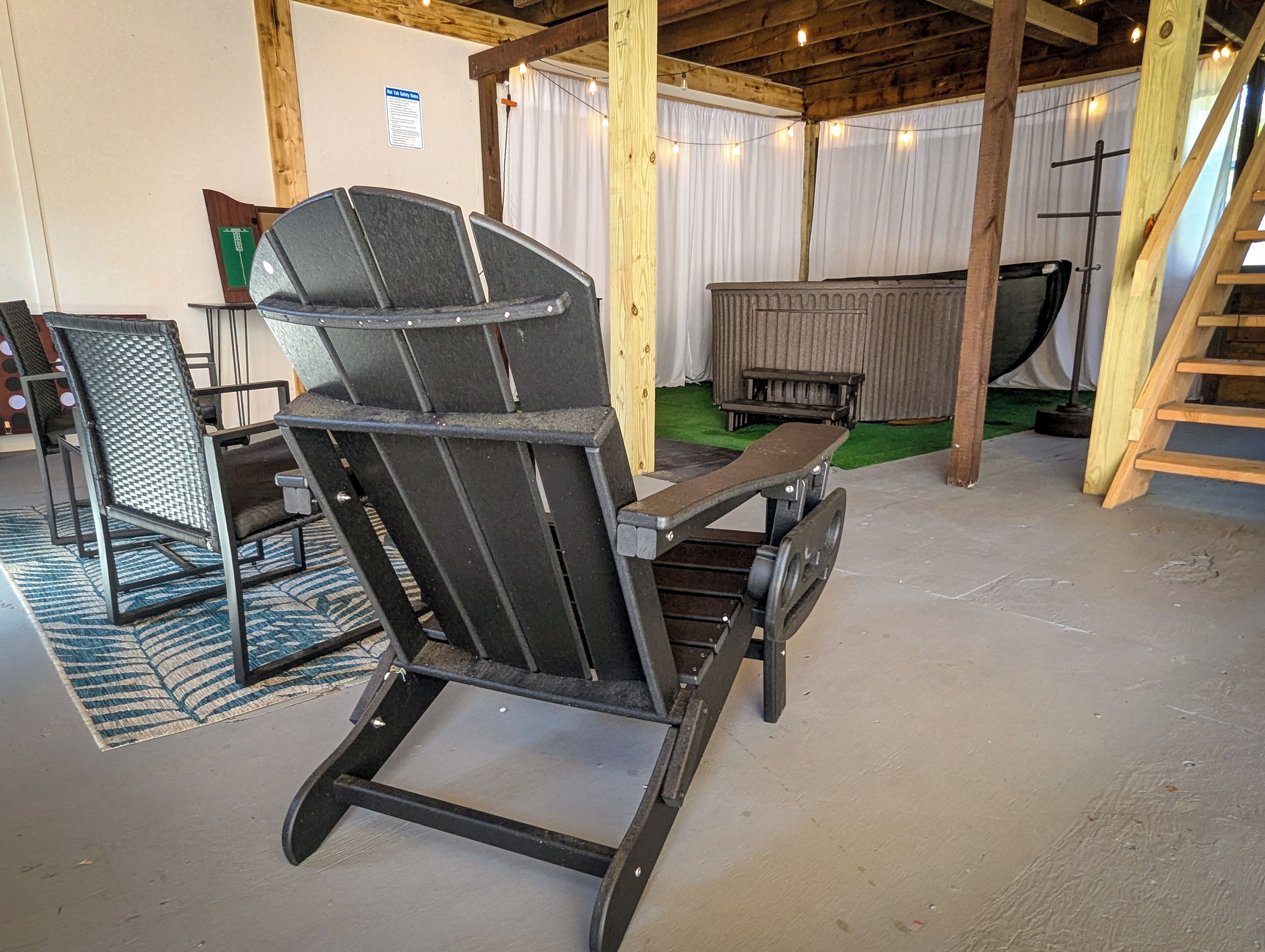A rustic wooden interior with a rocking chair, a wooden bench, and a ladder.