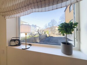 Un alféizar con una radio, una lámpara y una planta en maceta.