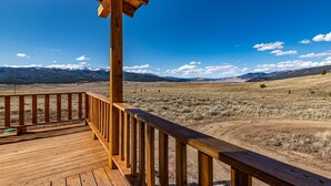 A wooden deck with a view of a mountainous landscape. - Mountain House Sleeps 18, Mins to Ski, Hike, Golf, Fish; Generator;  Fenced Yard (Angel Fire)