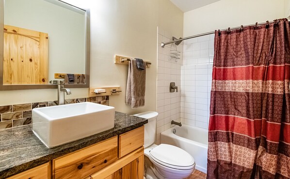 A bathroom with a large sink, toilet, and shower. - Mountain House Sleeps 18, Mins to Ski, Hike, Golf, Fish; Generator; Fenced Yard (Angel Fire)