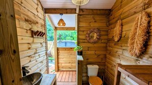 A rustic wooden cabin bathroom with a wooden sink, toilet, and a small window. - Kabane D'o, Gîte Tropical de Charme (Saint-François)