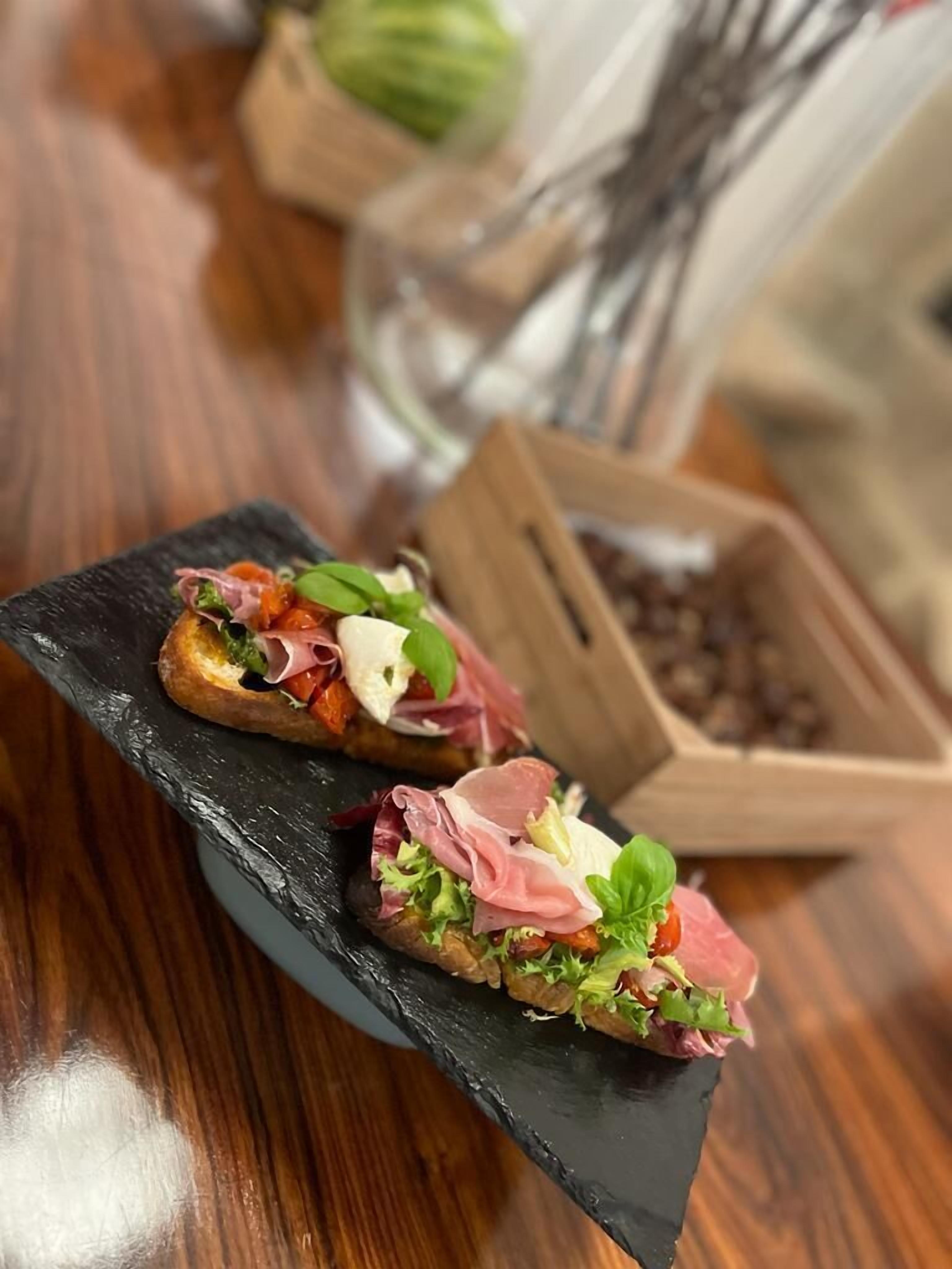 Two appetizers on a slate serving board.
