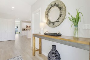 Cozy retreat with a console table, mirror, and greenery.