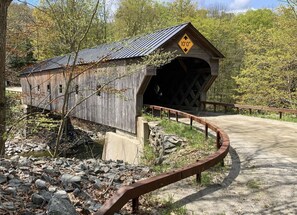 A covered bridge with a height restriction sign of 10 feet.