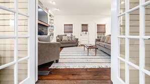 Amplia sala de estar con un sofá seccional grande, una mesa de centro y una estantería.