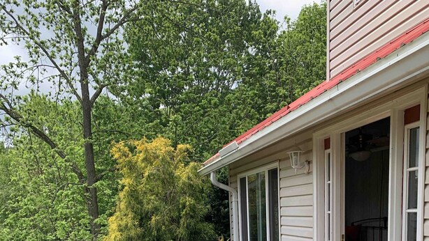 A wooden deck with outdoor furniture, a covered porch, and a view of a lush green landscape. - Cozy farmhouse with jacuzzi 10 min from Lansing, NC and Grayson Highlands (Lansing)
