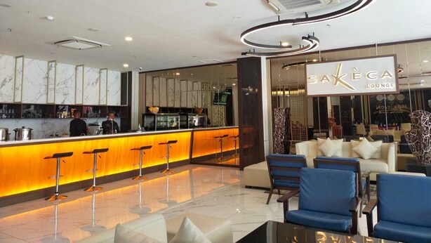 A modern lounge area with a bar, seating, and a sign reading "SAKÉCA LOUNGE". - Horison Abepura (Jayapura)