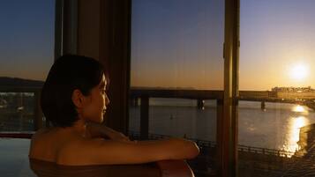 Enjoy a serene view of the bridge over the water from this room's expansive window.