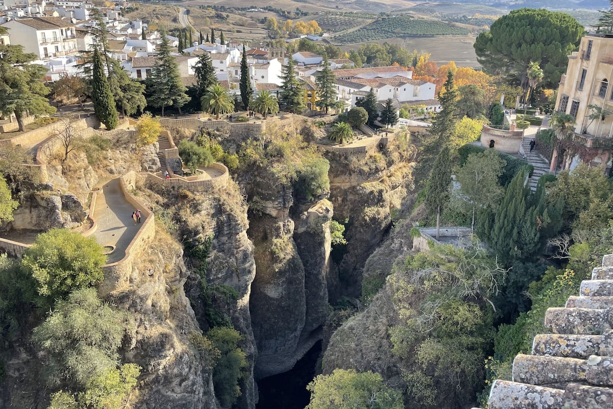 A town with a prominent cliffside and a winding road.