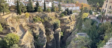 A town with a prominent cliffside and a winding road.