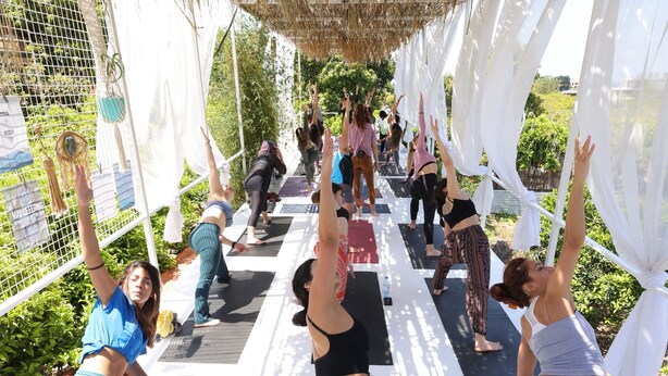 A group of people performing yoga on mats under a canopy. - Mayouli Nature Retreat (Batroun)
