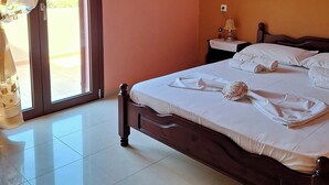 A bedroom with a bed, an air conditioning unit, a heart-shaped decoration, and a painting on the wall. - Dreamy South Sea View Villa Residence with Pool - Upper Level (Frangokastello)