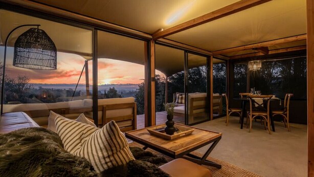 A modern interior with a sofa, dining table, and chairs.