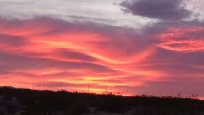 A sunset with a vibrant sky. - Off grid camping, bring tents or camper van. The only frill is a clean outhouse! (Joshua Tree)
