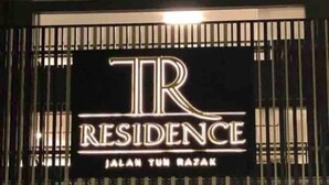 A sign for 'TR Residence' with a modern design, featuring the name and location 'Jalan Tun Razak'.