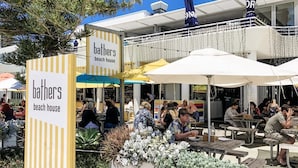 An outdoor seating area with tables and umbrellas at 'bathers beach house'. - Fremantle's Best | Urban Studio (Fremantle)
