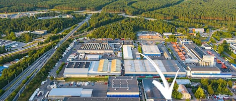 An industrial area with large buildings, parking lots, and roads.