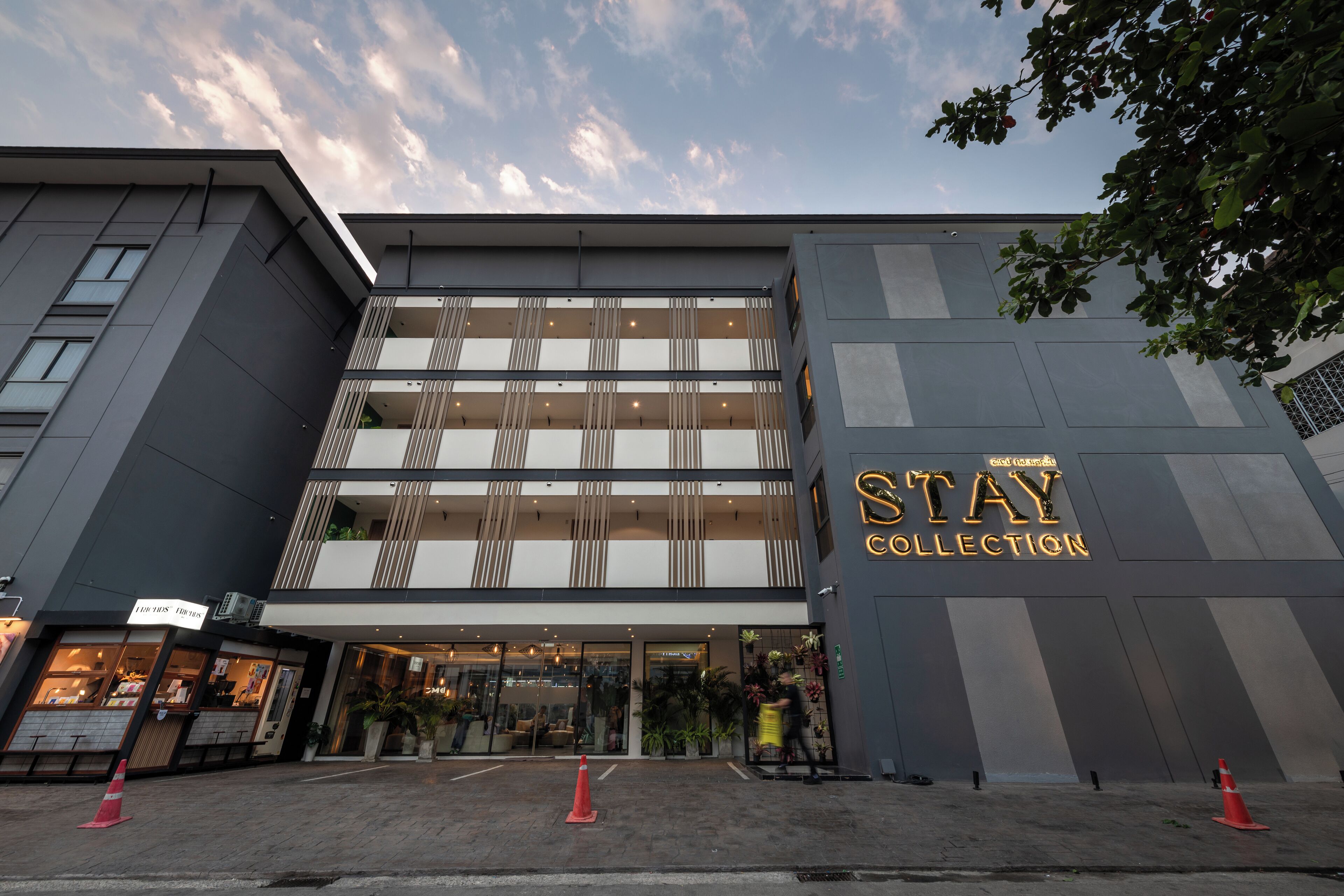 A modern building with a sign reading "STAY COLLECTION".
