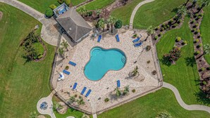 An aerial view of a property with a swimming pool, lounge chairs, and a small building. - Myrtlewood Resorts Serene Getaway Unit 105 (Myrtle Beach)