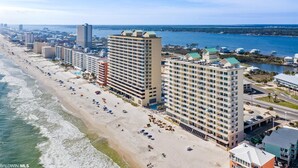 A coastal hotel with multiple high-rise buildings, a beachfront, and a marina. - Direct Gulf Front-Great View-Hot Tub-Swimthru Pool (Gulf Shores)