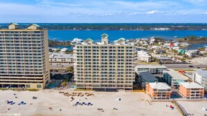 A coastal hotel with multiple buildings, a beach, and a view of the sea. - Direct Gulf Front-Great View-Hot Tub-Swimthru Pool (Gulf Shores)