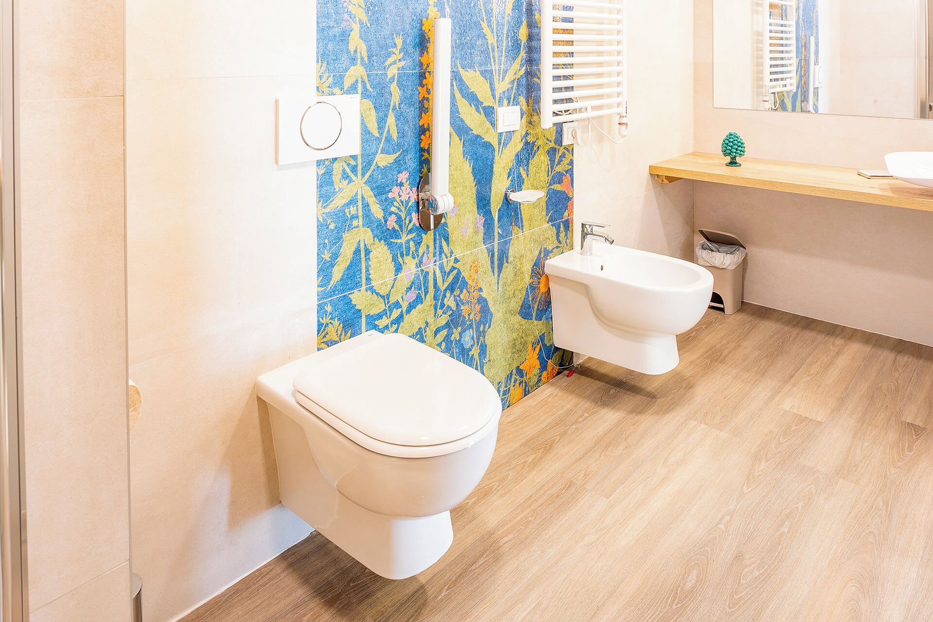 A bathroom with a toilet, bidet, and sink.