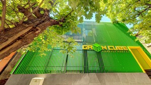 A green building with the text "GREEN CUBE CAPSULE HOSTEL" on the facade. - Green cube hostel (Sofia)