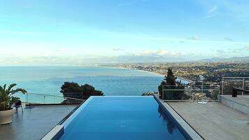 Seasonal outdoor pool, open 6:00 AM to 6:00 PM, pool umbrellas