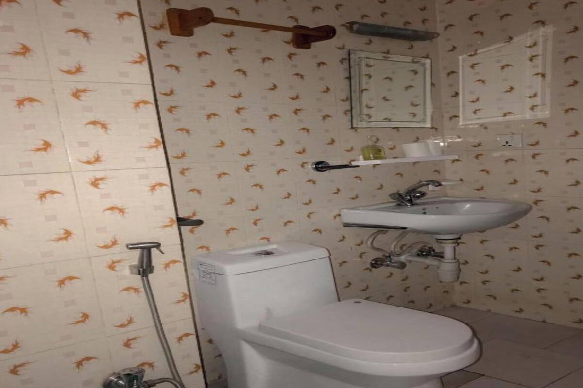 A bathroom with a toilet, sink, and shower.