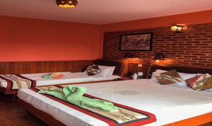 A hotel room with two beds, wooden headboards, a brick wall, and a ceiling light fixture. - MeroStay 152 B 2N B Guest House (Bhaktapur)