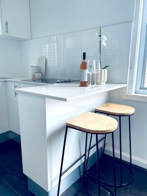 Enjoy dining and entertaining in this stylish kitchen with a wine station, stools, and a view.