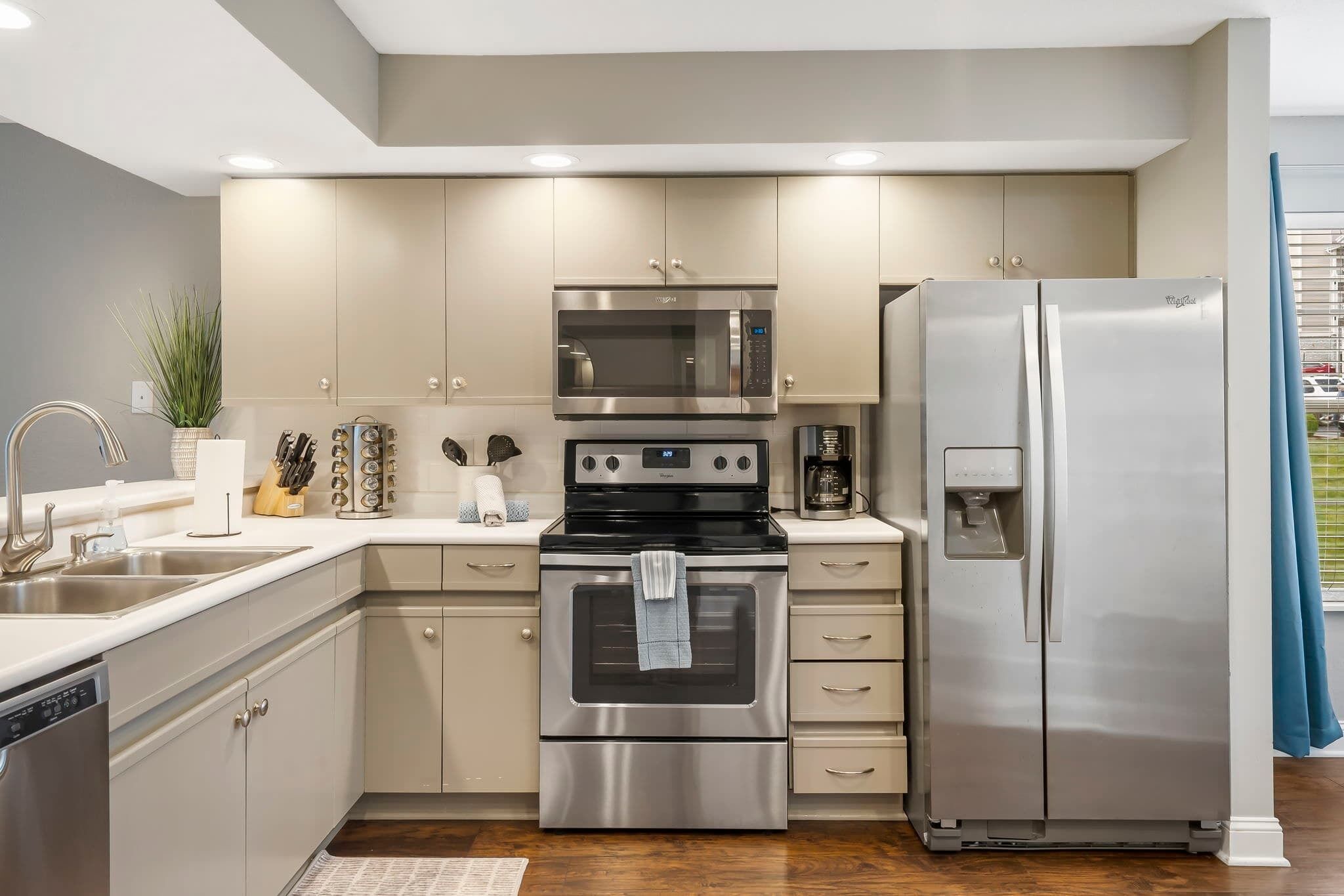 A modern kitchen with stainless steel appliances, including a microwave, oven, and refrigerator.