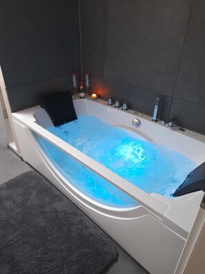 Jetted bath, hair dryer, towels, soap