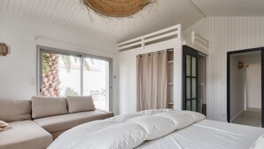 A bedroom with a bed, a sofa, and a large window. - 8 adults - 2 kids - Salt marshes and beaches (Noirmoutier-en-l´Ile)