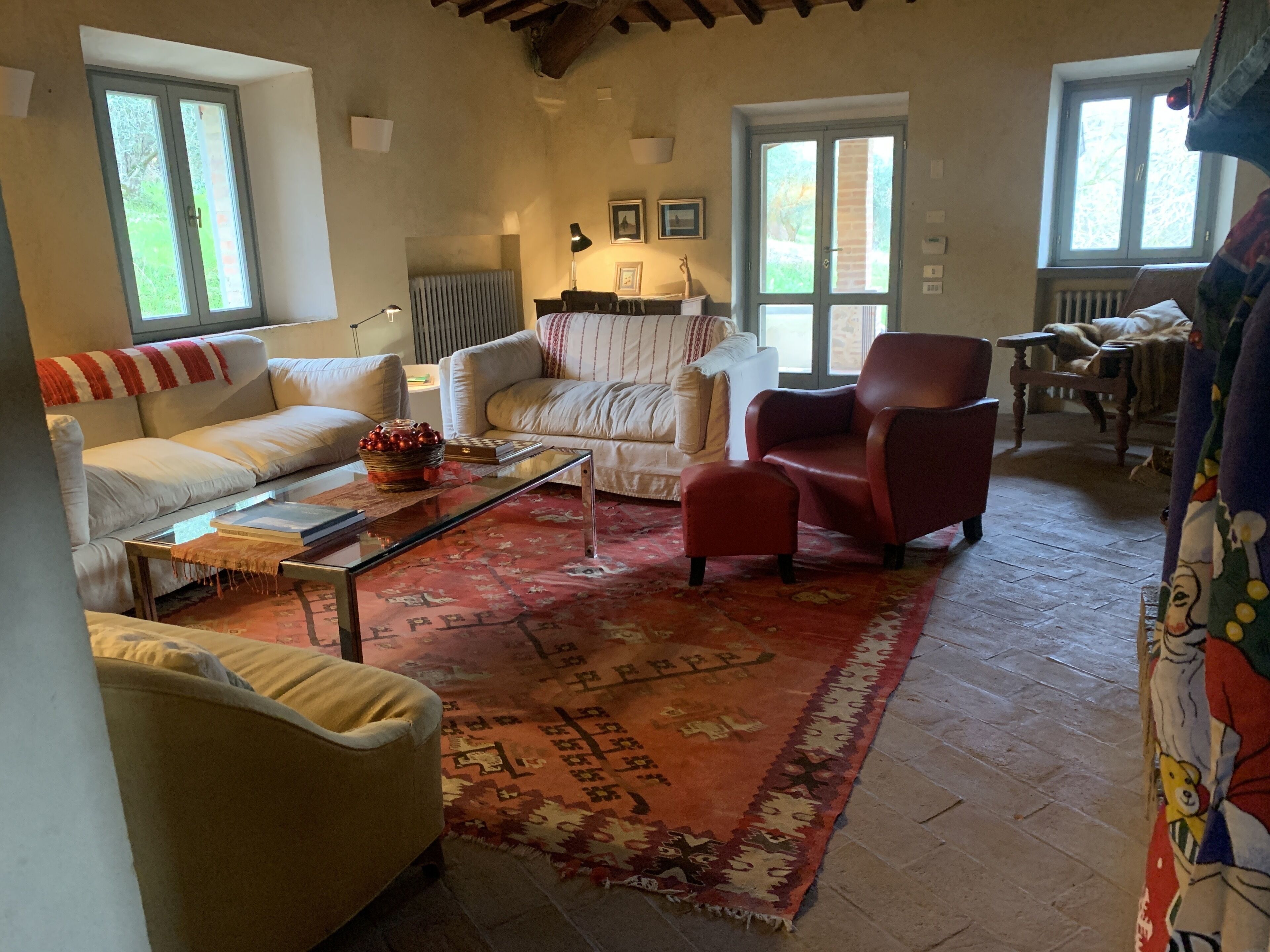 A cozy living room with a sofa, armchair, and a coffee table.