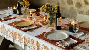 A table set for a meal with plates, glasses, and candles. - Podere Fontebernardi, authentic Tuscan farmhouse overlooking Pienza. (Monticchielli)