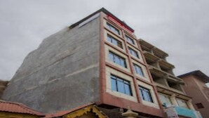 A multi-story building with a flat roof and a balcony on the upper floors. - MeroStay 165 HOTEL RI (Kathmandu)