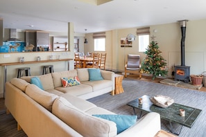 A living room with a sofa, coffee table, and a fireplace.