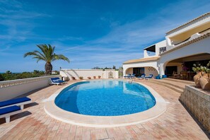 A heated pool, sun loungers