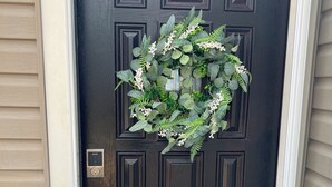 A dark wooden door with a decorative wreath and a keypad lock. - This place is peaceful  to stay in, Relax and enjoy. (Greenville)