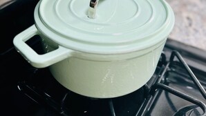 A green pot on a stove with a lid. - Coastal Casita by the River (New Bern)