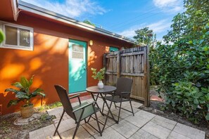 Enjoy dining or socializing in this patio area with a round table and two chairs.